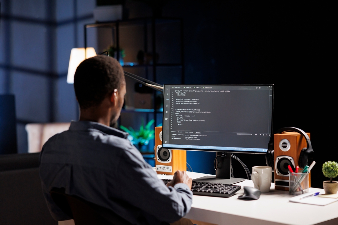 male developer working behind laptop