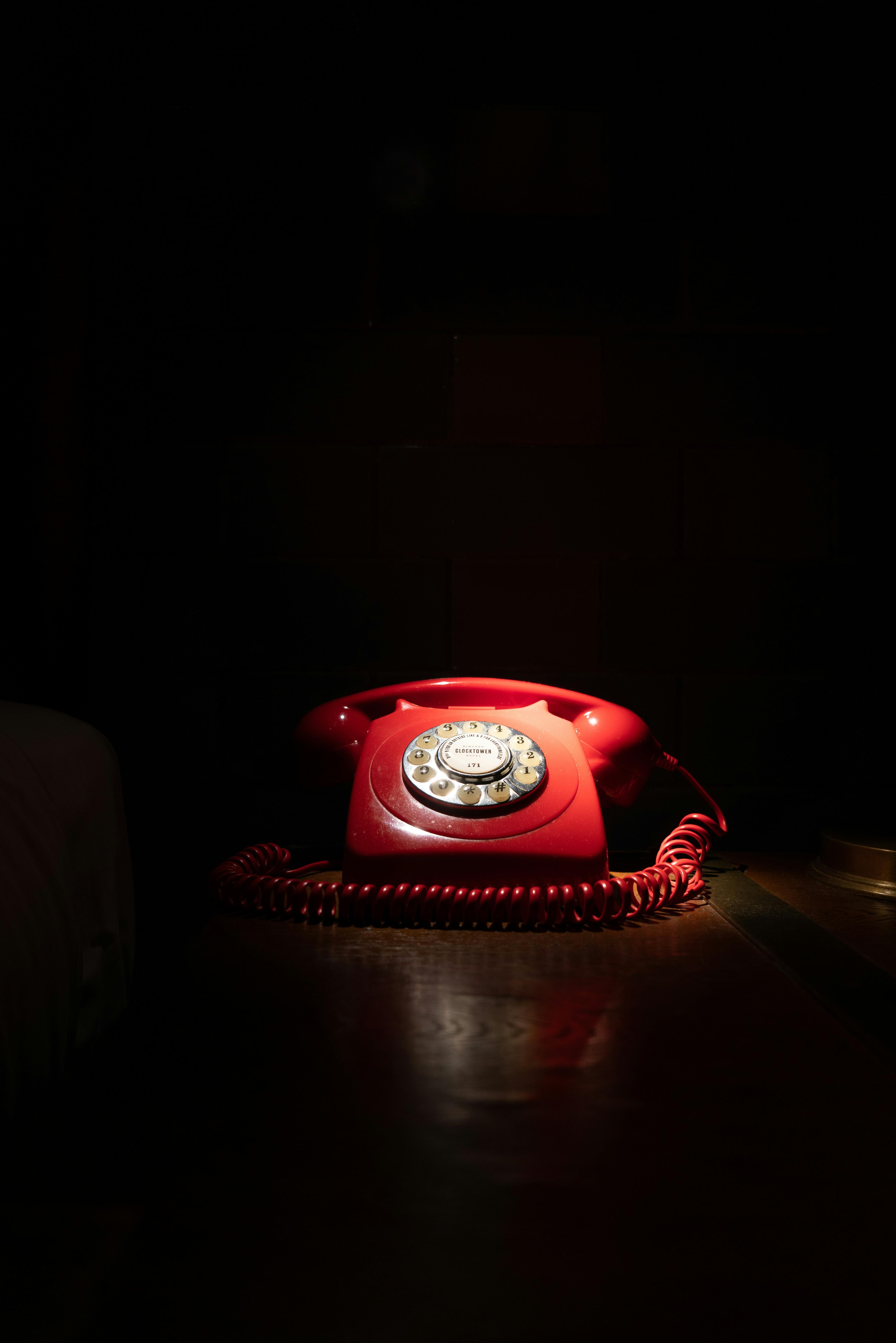 Image of a red phone  with  a black  background